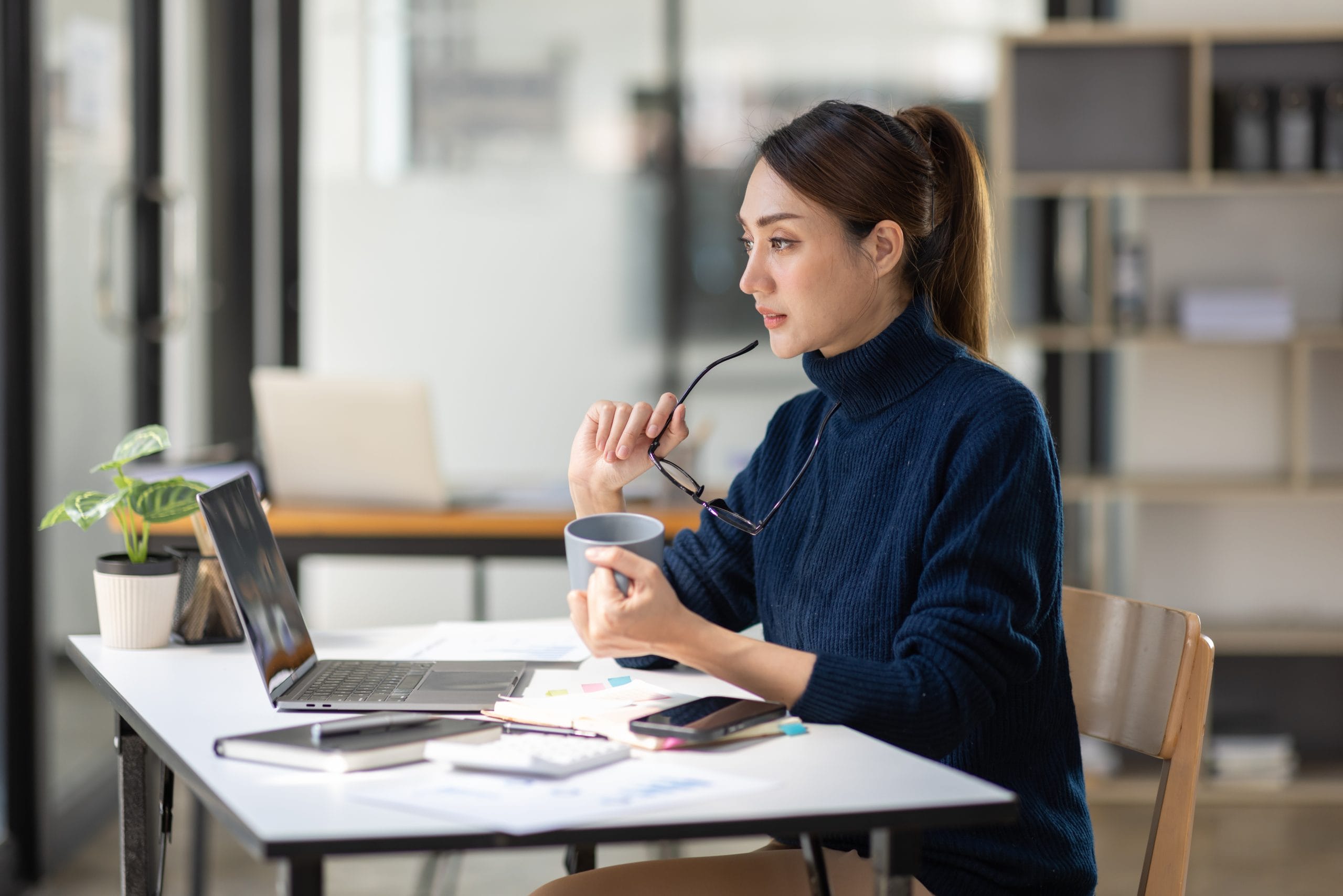 Business woman in deep thought at her computer